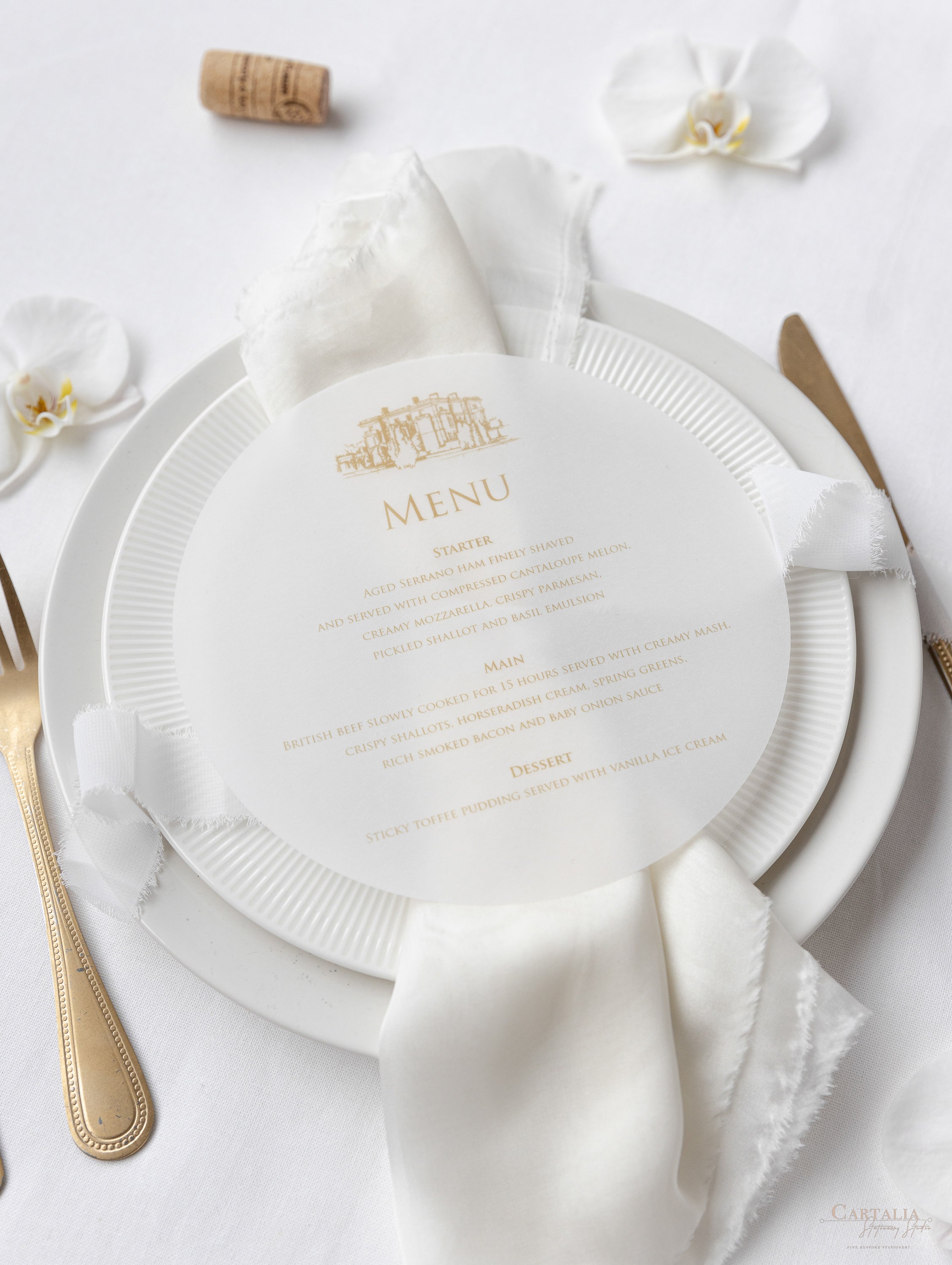 A menu card in off-white shades with a punched-out church and vellum paper